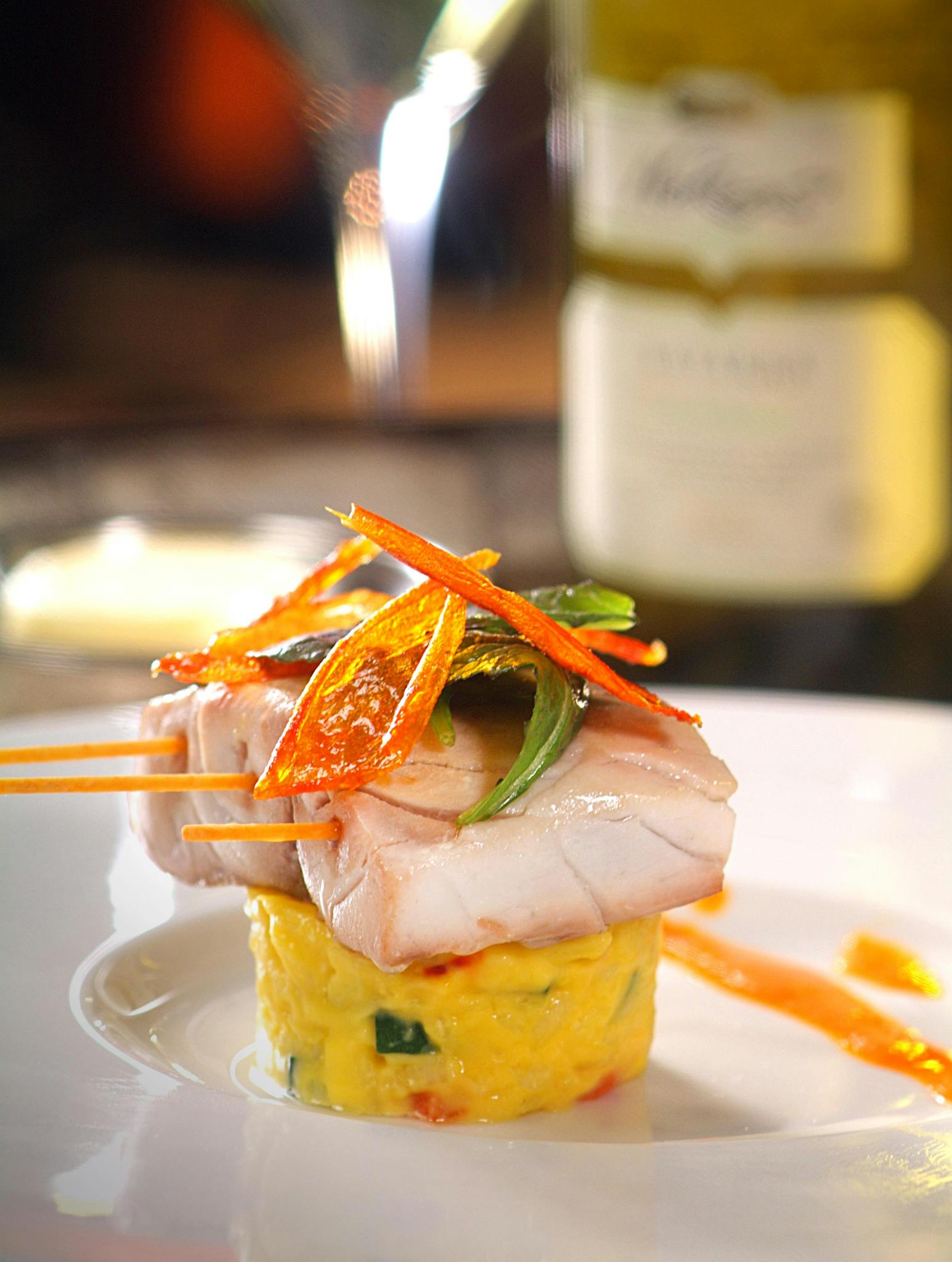 Elegant plated seafood dish with vegetables at a fine dining restaurant.