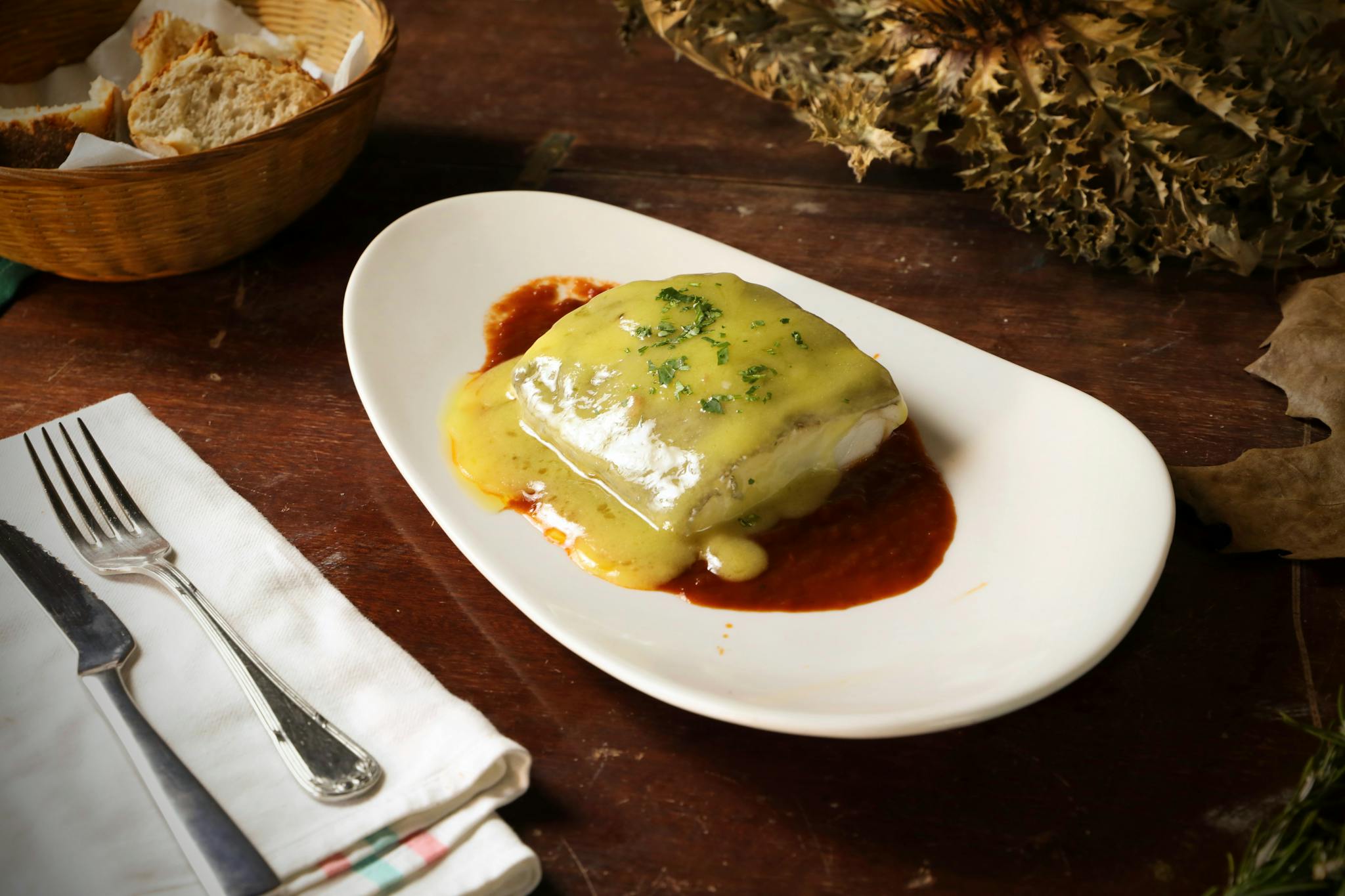 Gourmet dish with creamy sauce served on a wooden table, perfect for food lovers.